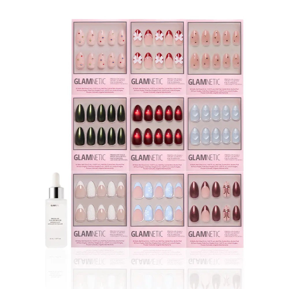 Nine boxes of glamnetic Almond Joys press-on nails are arranged in a grid on a white background, featuring styles like glitter French tips and holiday designs, with a small white dropper bottle placed in front. - Product image