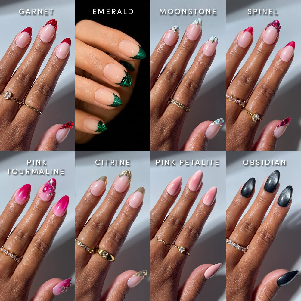 Eight close-up shots of hands with manicured nails, each featuring a different style from glamnetic’s Almond Alignment collection: Garnet, Emerald, Moonstone, Spinel, Pink Tourmaline, Citrine, Pink Petalite, and Obsidian. These gemstone-inspired designs display elegant almond press-on nails and unique patterns reminiscent of precious stones.