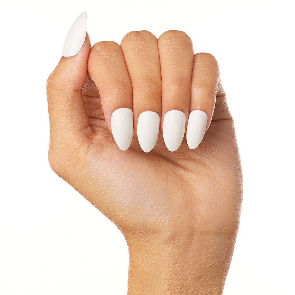 A hand with medium brown skin is shown in a fist, displaying long, almond-shaped glamnetic Angel press-on nails in glossy white, set against a plain white background. - Product image