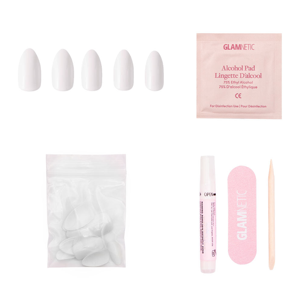 The glamnetic Angel press-on nail kit includes five white almond-shaped nails, an alcohol pad, extra nails in a resealable bag, nail glue tube, pink file, and wooden cuticle stick—displayed on a white background. - Product image