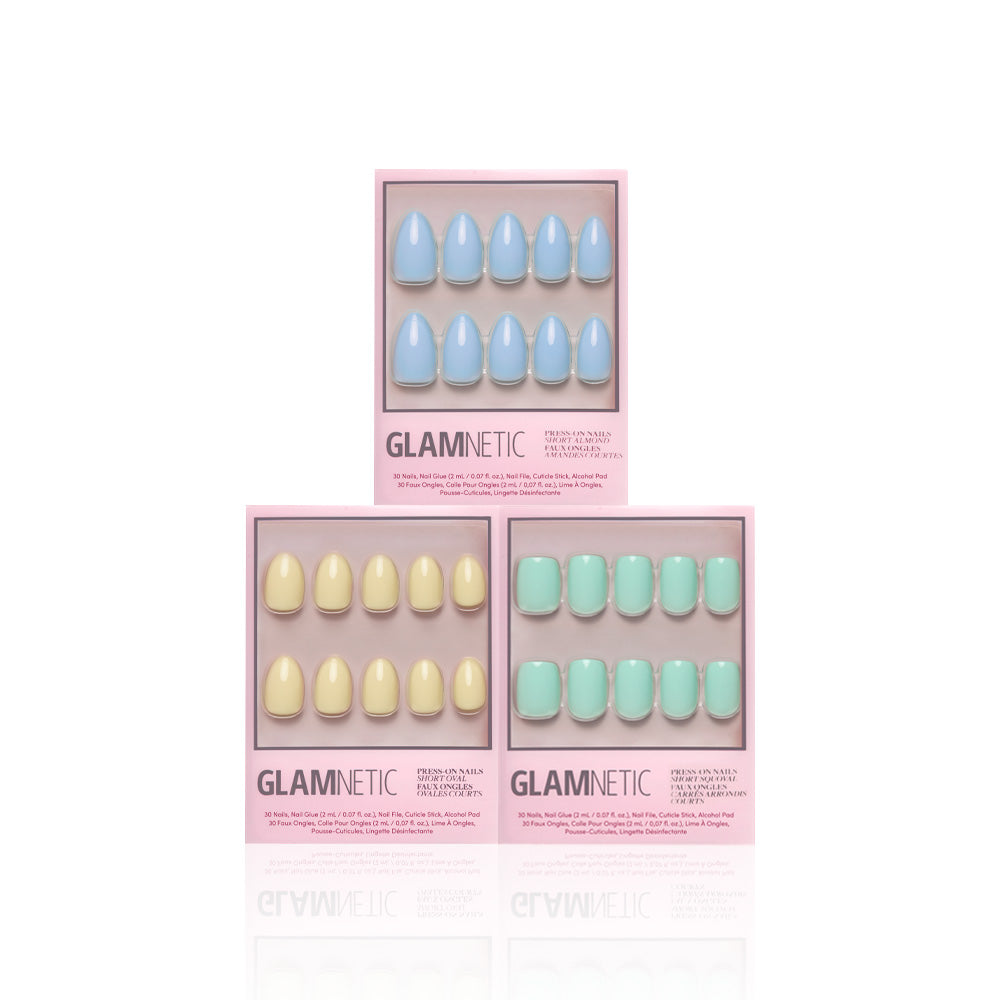 Three boxes of Glamnetics Anns Palette press-on nails in pastel blue, yellow, and green are arranged in a triangle on a white background. Each box shows glossy finish nails through a clear window—ideal for spring manicures. - Product image