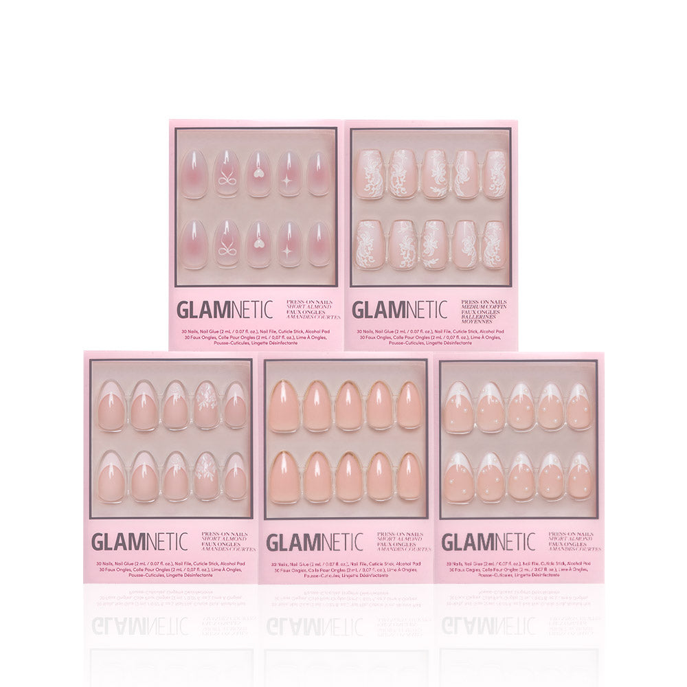 Five boxes of glamnetic Anns Sweethearts press-on nails in assorted nude and pink designs, featuring French tips, short almond shapes, and white floral, heart, and bow patterns, displayed on a white background. - Product image