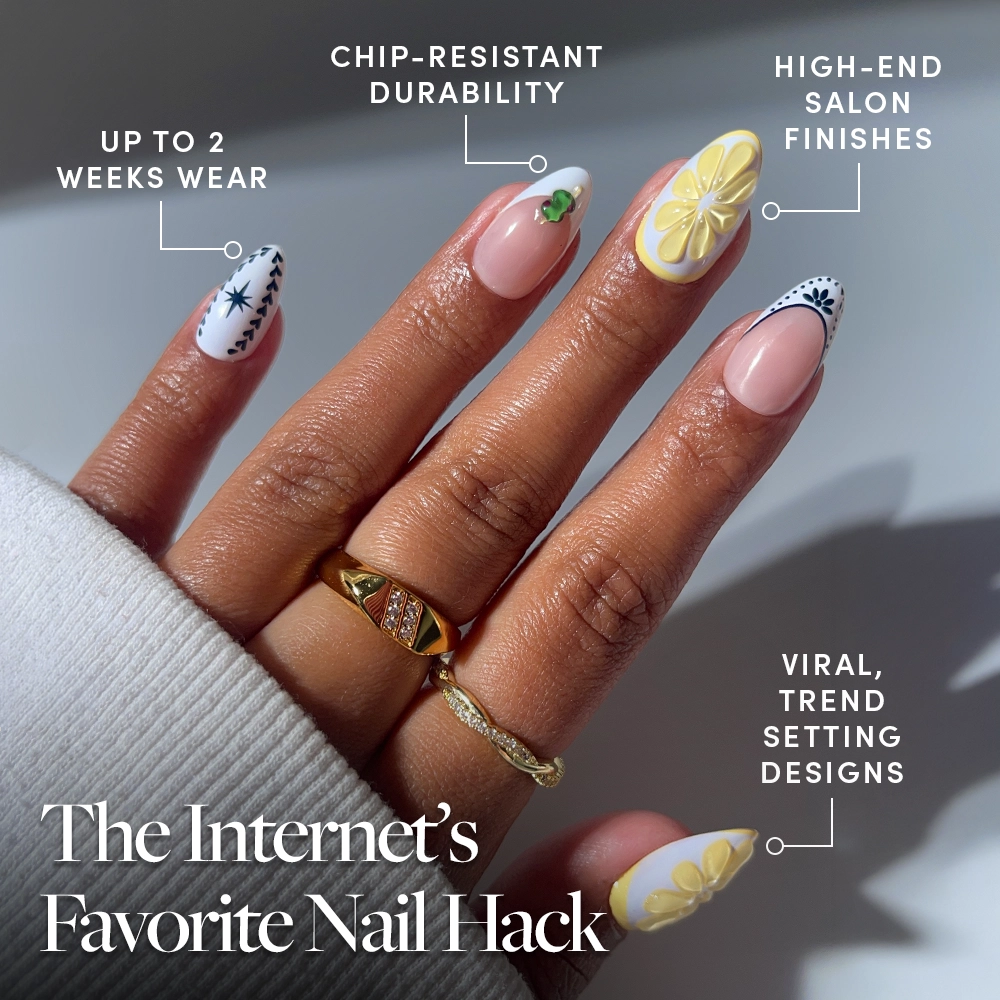 A hand with neatly manicured short almond nails displays floral and lemon slice designs. Text points out glamnetic’s Aperitivo Hour press-ons, known for chip-resistant durability, viral trendy style, and luxe finish that lasts up to 2 weeks. - Product image