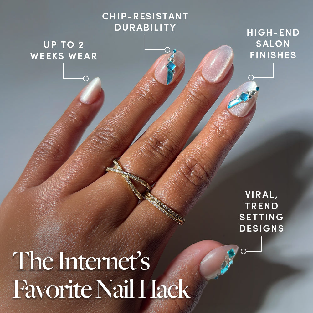 A hand adorned with gemstone nail art and glamnetic's Aquamarine press-on nails in chic short oval shapes is labeled with benefits: Up to 2 weeks wear, Chip-resistant durability, High-end salon finishes, and Viral, trend-setting designs. Text reads: The Internet’s Favorite Nail Hack. - Product image