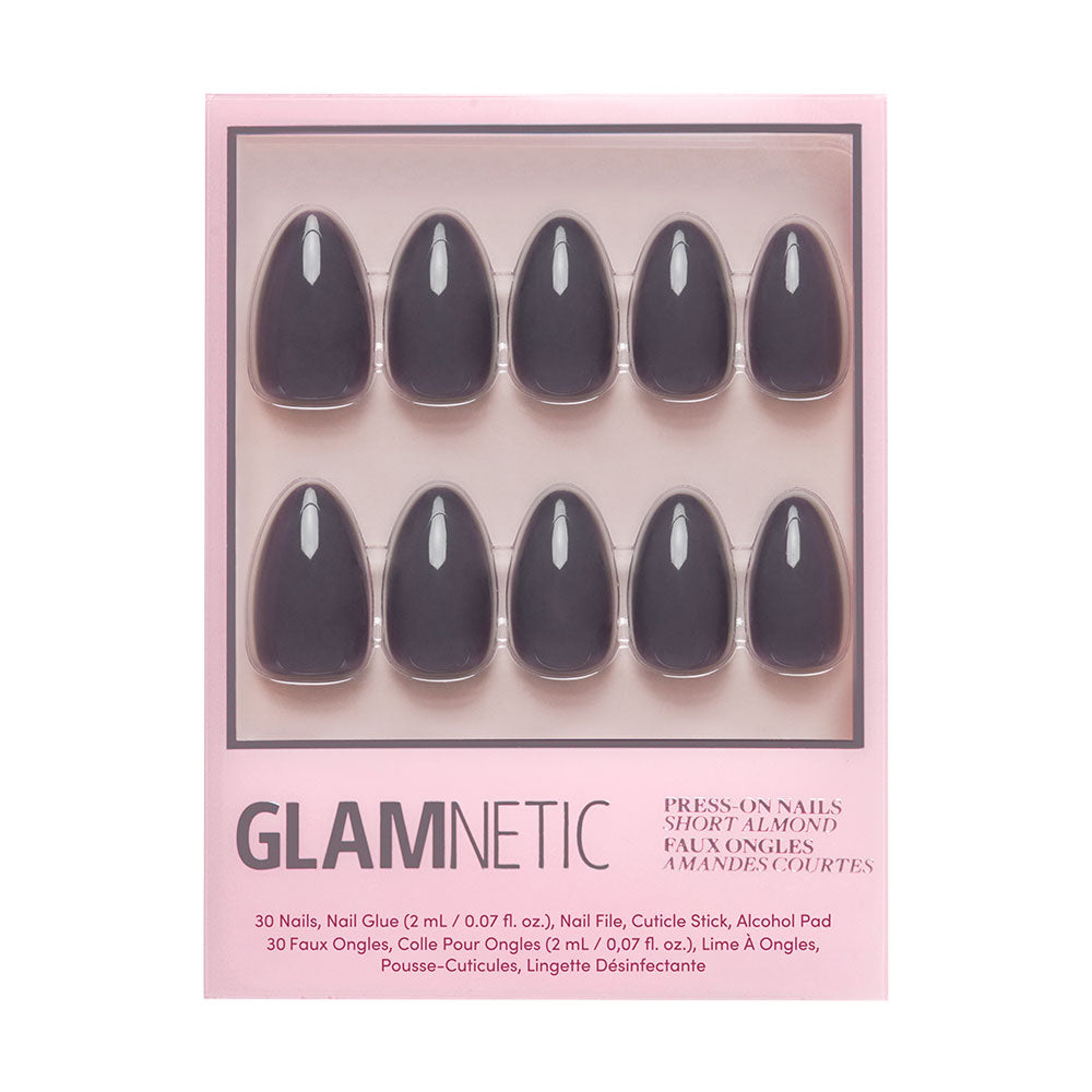 A box of glamnetic Ash Gray nails with 10 short, ash gray nails, nail glue, a cuticle stick, and an alcohol pad in pink packaging with black and metallic text. - Product image