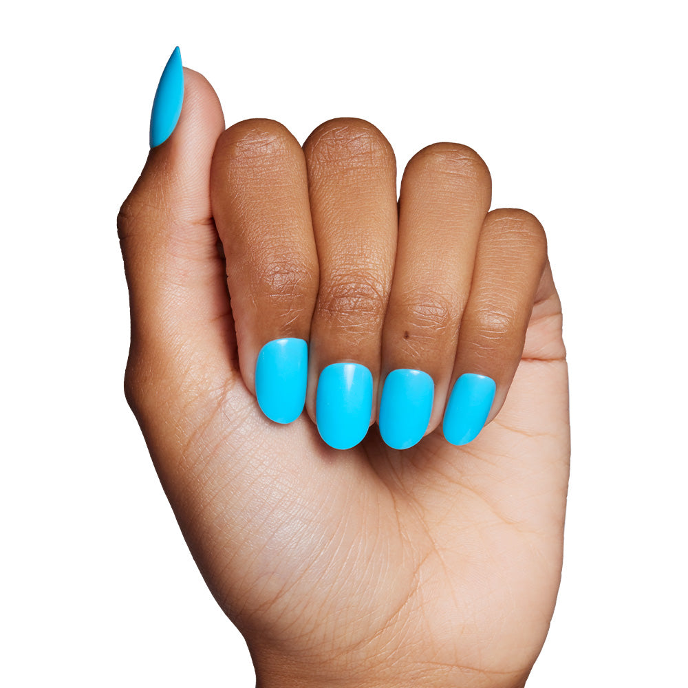 A hand with medium brown skin displays glamnetics Azure Blue nails, vibrant and neatly shaped, set against a plain white background—perfect for summer fun. - Product image