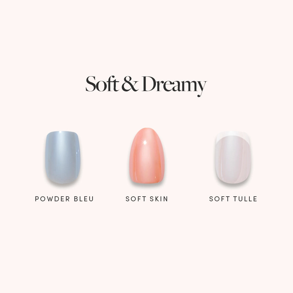 Three salon-quality nail polish swatches from glamnetic’s "Soft & Dreamy" collection—Powder Bleu (light blue), Soft Skin (peachy pink), and Soft Tulle (sheer pale pink)—are displayed on a light background, each featuring a high-shine glazed finish that resembles professional press-on nails. - Product image