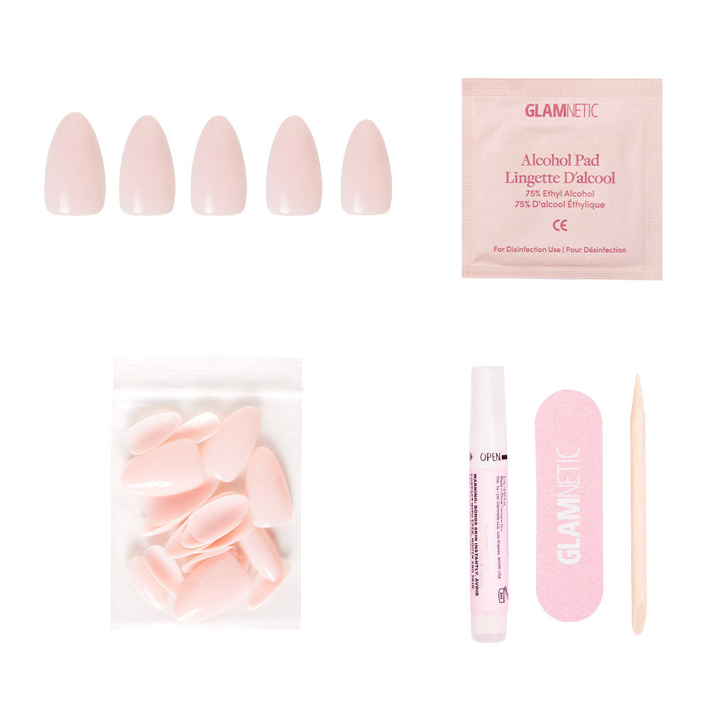 The glamnetic Ballet Pink set includes glossy short almond press-on nails, extra nails, nail glue, an alcohol pad, a pink nail file, and a wooden cuticle stick—displayed on a white background. - Product image