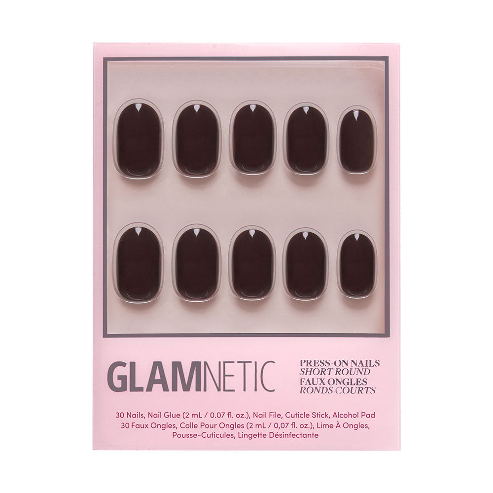 A set of glamnetic Bark Brown short round press-on nails in dark brown with a glossy finish, arranged in two rows inside a pink box. Includes nail glue, file, cuticle pusher, and alcohol pad. - Product image