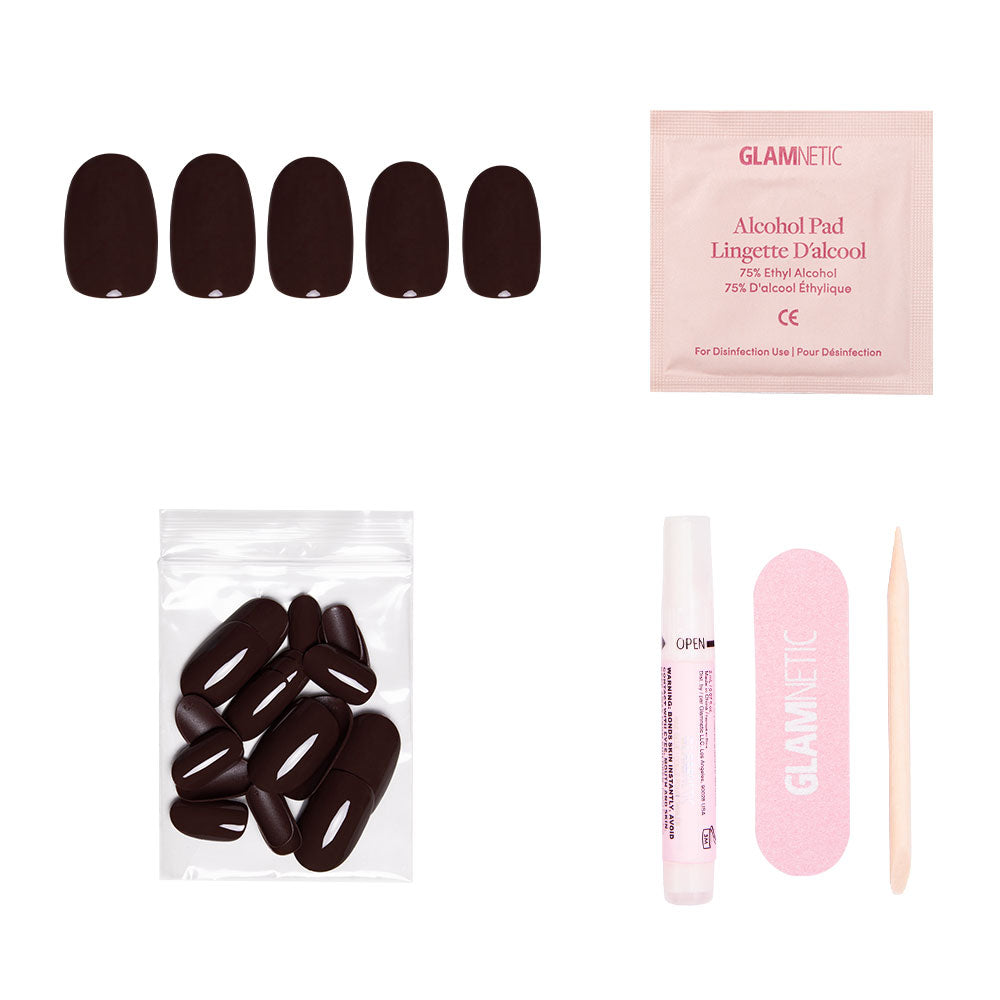 The glamnetic Bark Brown set includes glossy finish nails, extra nails in a plastic bag, an alcohol pad, nail glue tube, pink nail file, and wooden cuticle stick—all arranged on a white background. - Product image