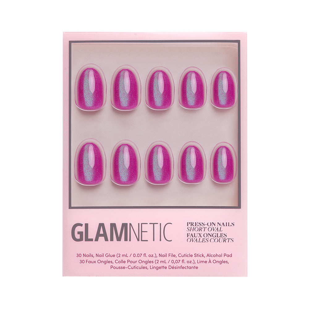 A box of glamnetic Berry Fizz press-on nails in a short oval shape, including ten shimmery pink nails with a velvet metallic finish, shown in clear packaging with product details at the bottom. - Product image