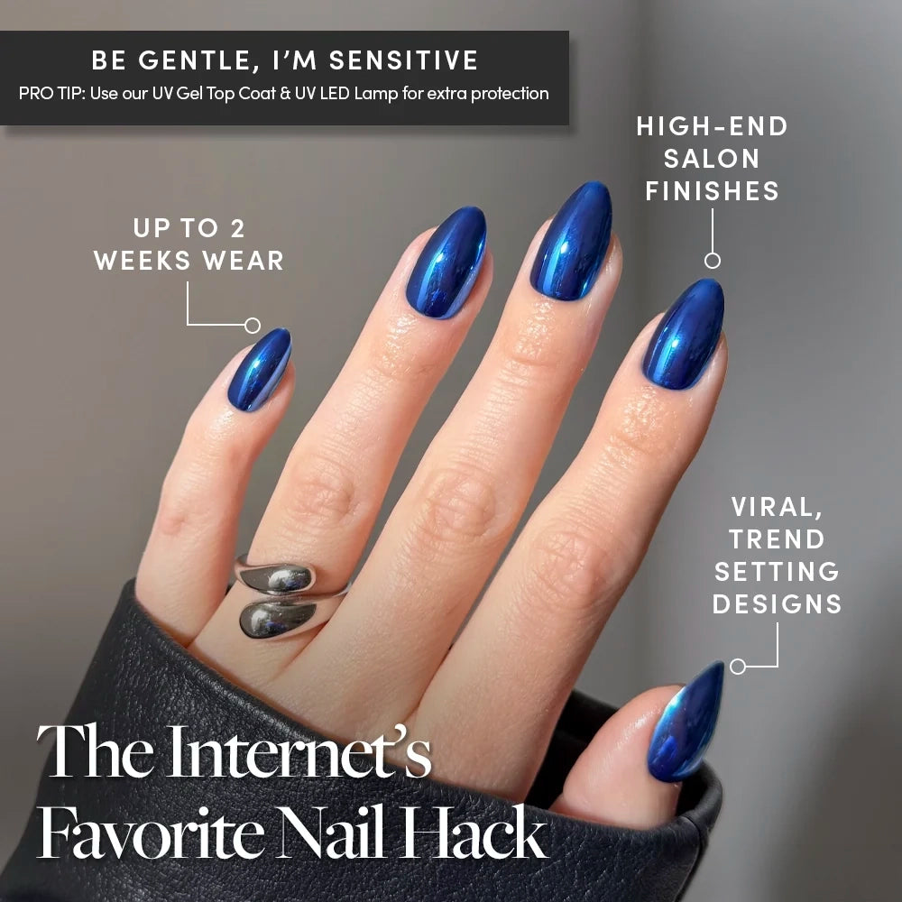 Blue Steel - A hand with short almond nails in the metallic blue Blue Steel shade by Glamnetic, featuring text overlays highlighting high-end salon finishes, up to two weeks of wear, and trending designs.