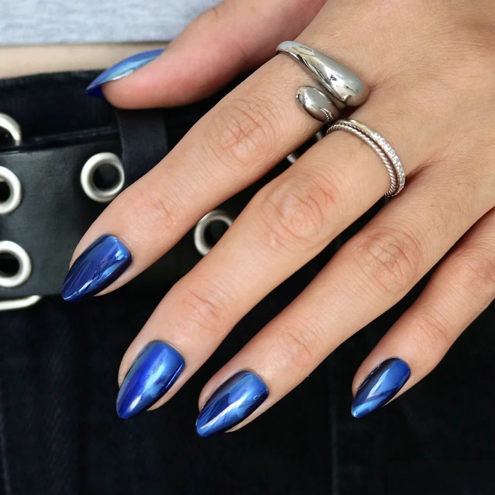 Blue Steel - Hand with short almond nails in a metallic, blue chrome finish from the Glamnetic Blue Steel set.