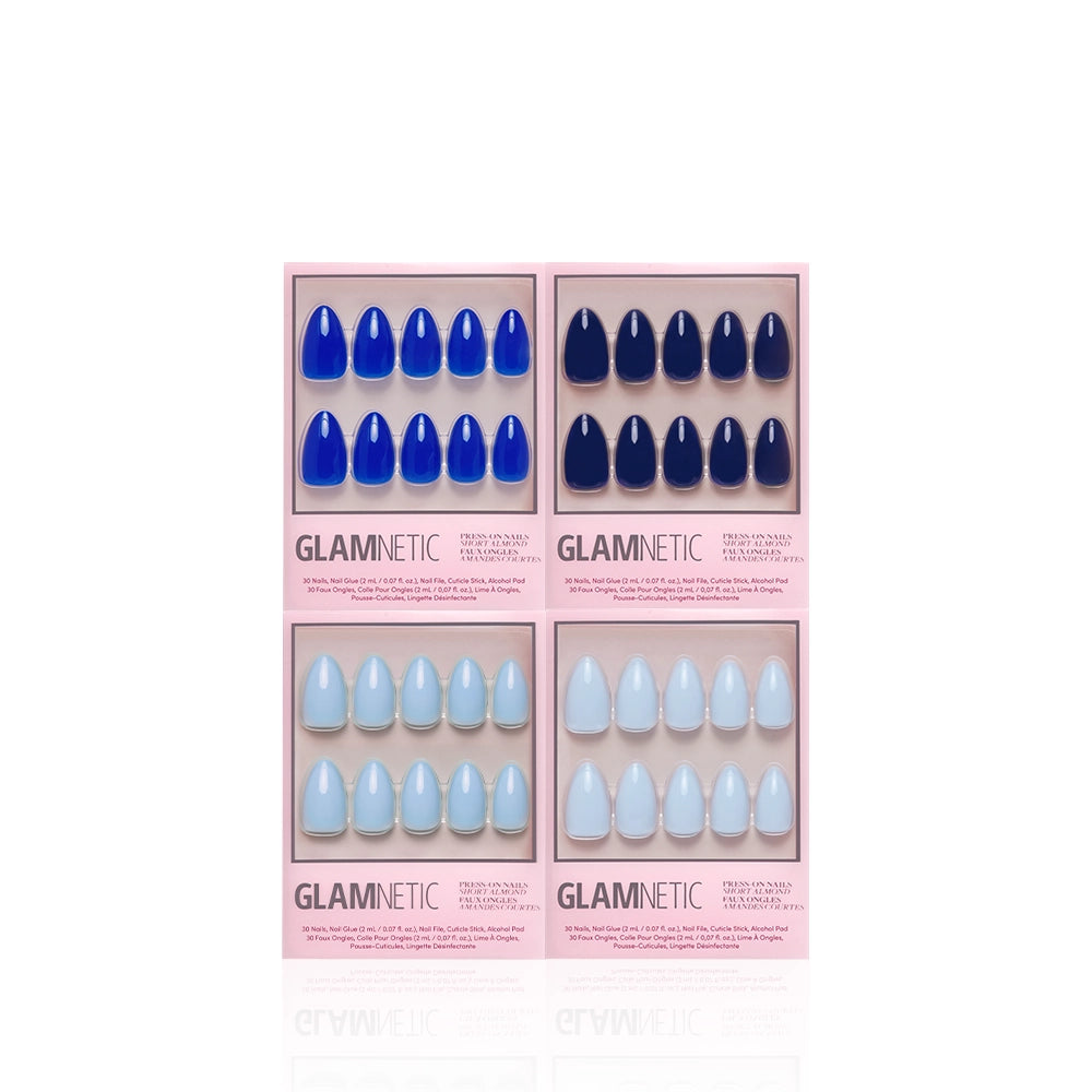 Four sets of glamnetic Blue Mood Almonds salon-quality press-on nails, packaged in rectangular pink boxes and arranged in two rows. The top two sets feature dark blue shades, while the bottom two display light blue hues. Each box includes ten short almond-shaped press-on nails. - Product image