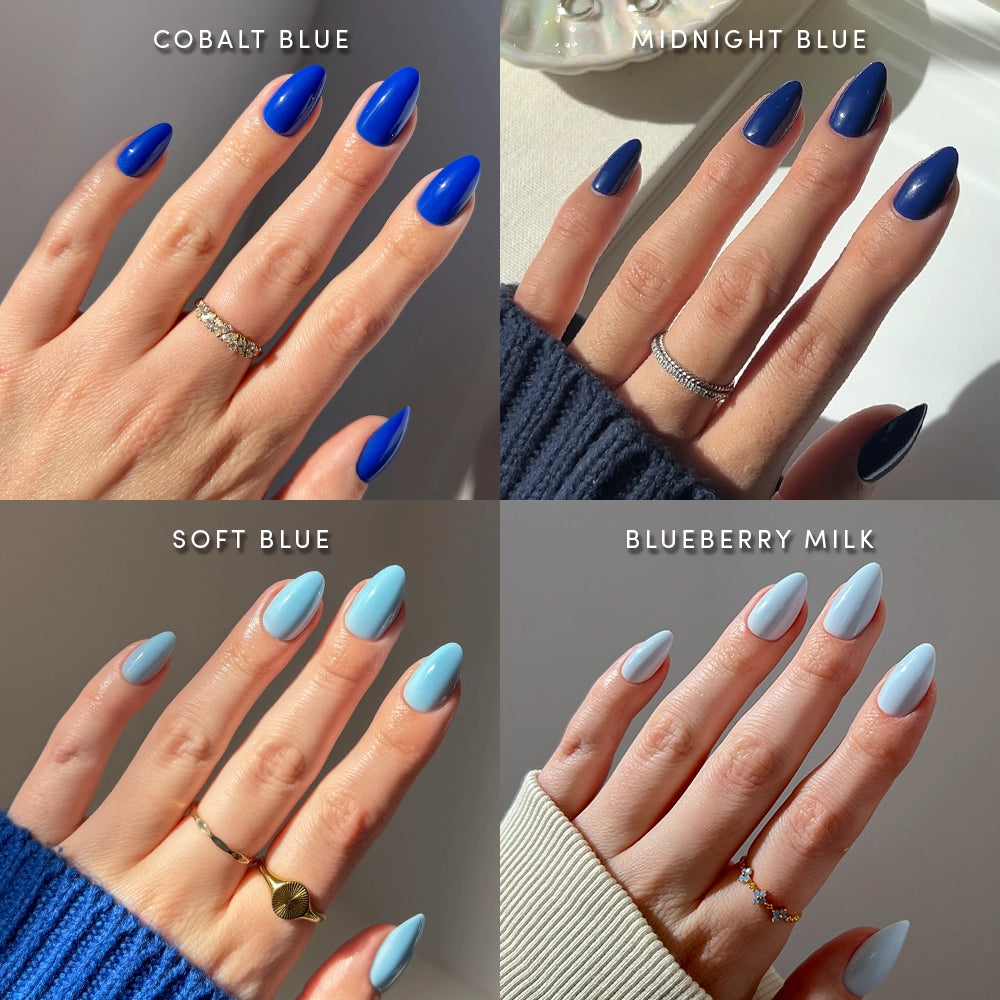 Four hands with manicured nails in various blue shades—cobalt blue, midnight blue, soft blue, and blueberry milk—beautifully showcase glamnetic’s Blue Mood Almonds salon-quality press-on nails. Each hand is displayed individually, labeled with its specific nail color, and styled with rings and distinct sleeve colors that complement the short almond-shaped press-ons. - Product image