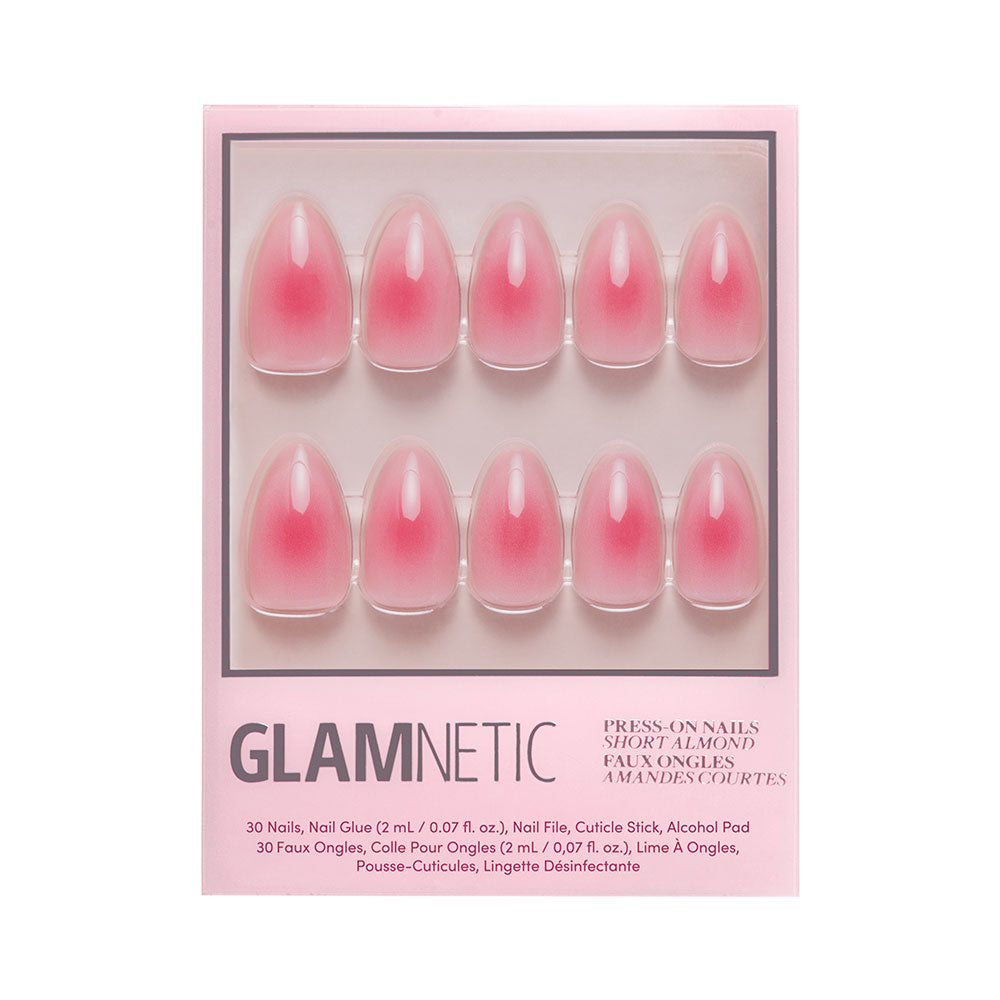 The glamnetic Blushing Aura set includes 10 short almond nails with a pink ombre and abstract dark pink center, plus nail glue, file, cuticle stick, and alcohol pad. - Product image