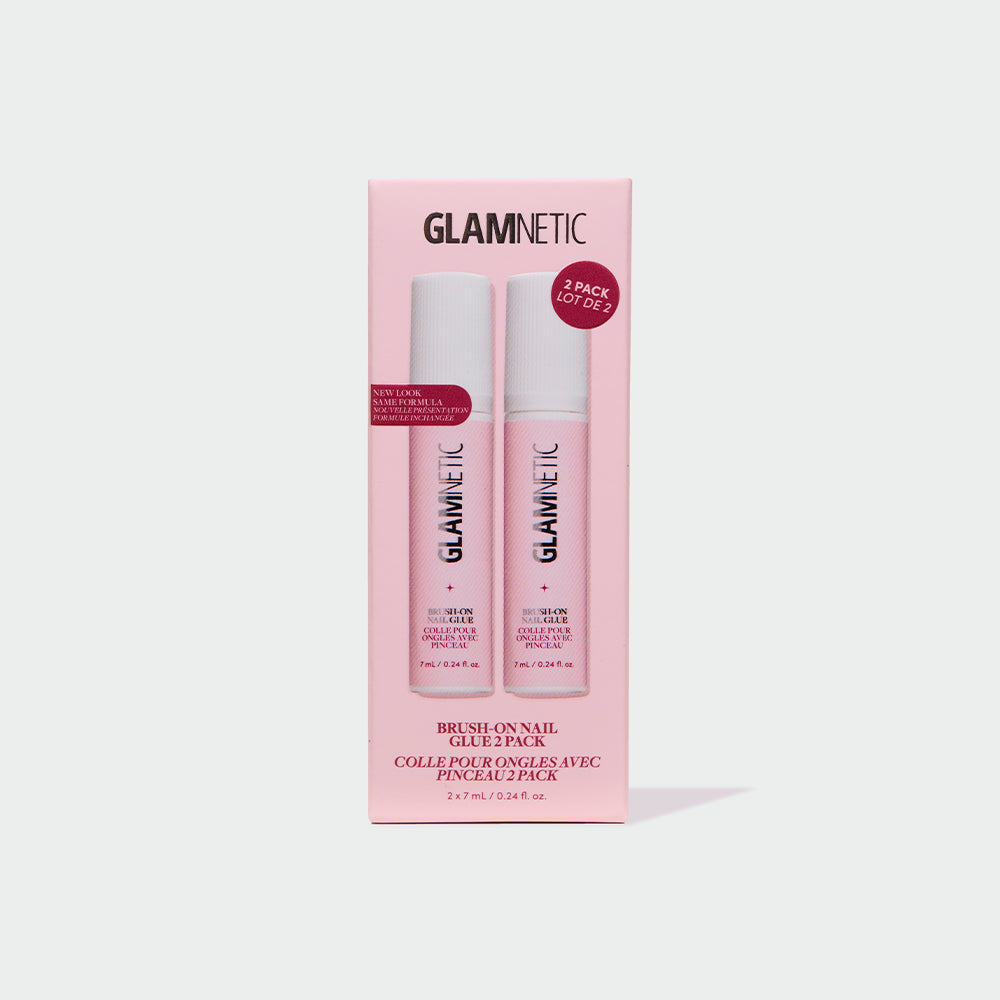 A light gray background showcases a pink box labeled glamnetic Glue Duo, featuring two bottles of Brush-On Nail Glue for achieving salon-quality nails at home. The packaging displays product information in both English and French, with a "2 pack" label clearly visible.