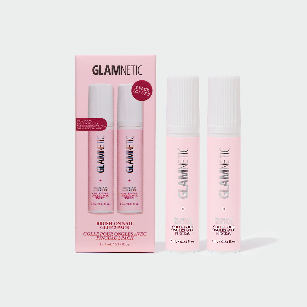 Two pink tubes of glamnetic Glue Duo stand beside their matching pink box, which features the glamnetic logo and product details in bold black and white text. Specially formulated for seamless press-on nail application, this adhesive delivers salon-quality results right at home.