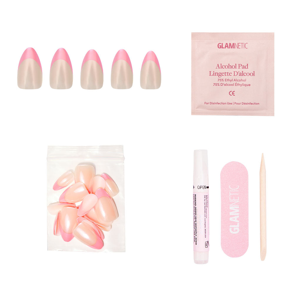 The glamnetic Bubble Gum Glaze press-on nail kit features almond-shaped pink French tips, extra nails, nail glue, an alcohol pad, a pink nail file, and a wooden cuticle stick—all arranged on a white background. - Product image
