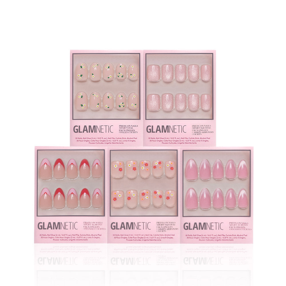 Five boxes of glamnetic Budding Romance Glossy Nail Set are displayed, each containing ten Short Almond press-on nails in various pink designs, including florals, solid pinks, and pink tips, neatly arranged against a white background. - Product image