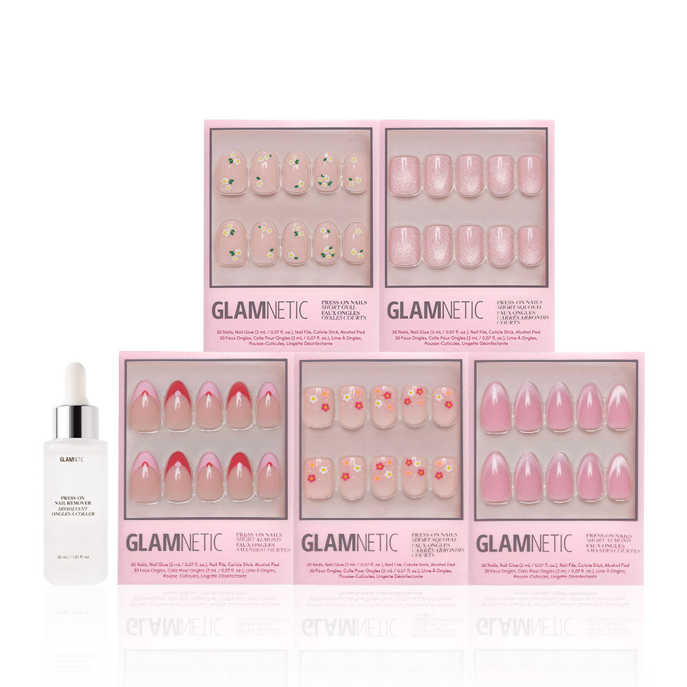 Six boxes of glamnetic Budding Romance press-ons in pink and floral designs are arranged in two rows, with a white Glamnetic Press-On Nail Remover bottle to the left of the bottom row. - Product image