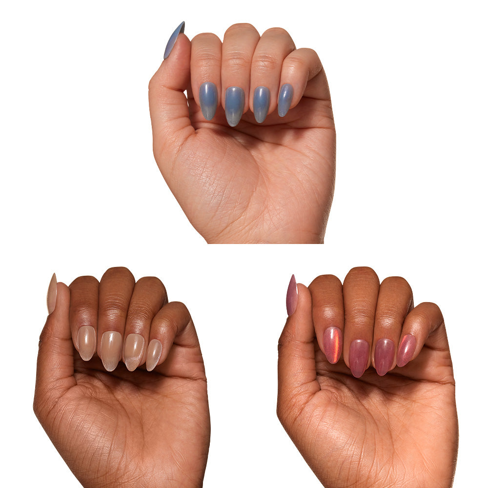 Three hands with manicured, short almond nails in blue, nude, and mauve-pink—each featuring the dimensional velvet finish of glamnetic’s Velvet Haze. This chic, modern look is completely vegan and cruelty free. - Product image