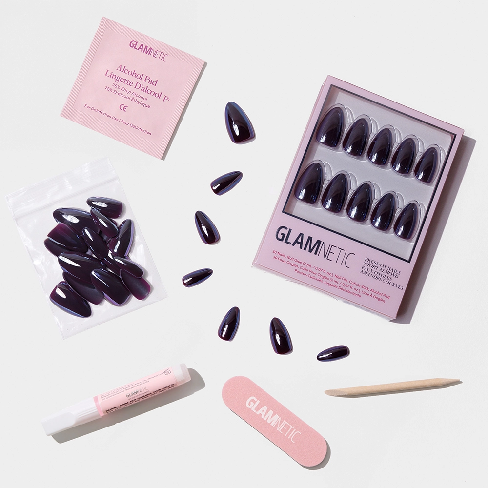 The glamnetic Burgundy Chrome set features reusable press-on nails in a purple shade, a pink nail file, wooden cuticle stick, nail glue, alcohol pad, and extra nails—ideal for fans of short almond chrome styles. - Product image
