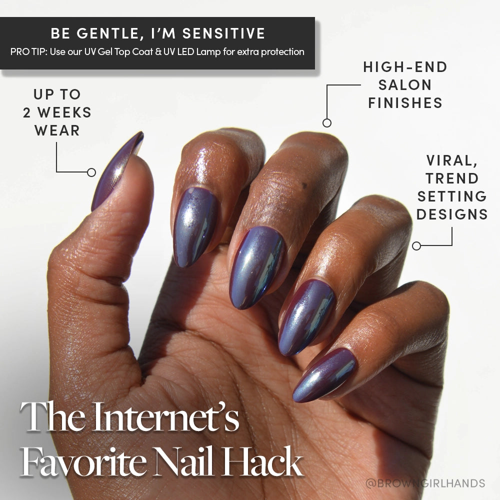 A hand with short almond glamnetic Burgundy Chrome nails in metallic purple is shown against a white background. These reusable press-ons deliver viral designs and a salon-quality finish for up to two weeks—the Internet’s Favorite Nail Hack. - Product image