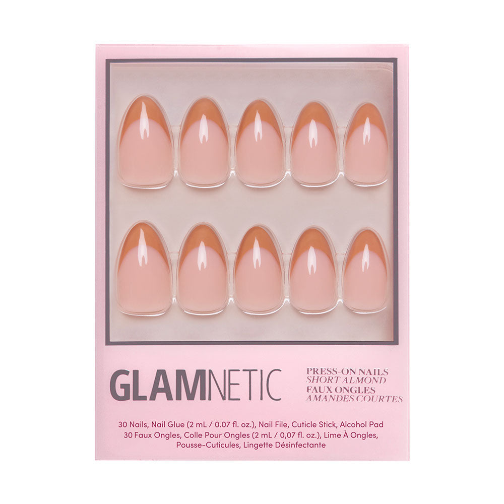 A box of glamnetic Café Crème reusable press-on nails in a short almond shape and nude pink shade. The set displays ten nails in packaging with cozy vibes, plus text listing the contents and instructions. - Product image