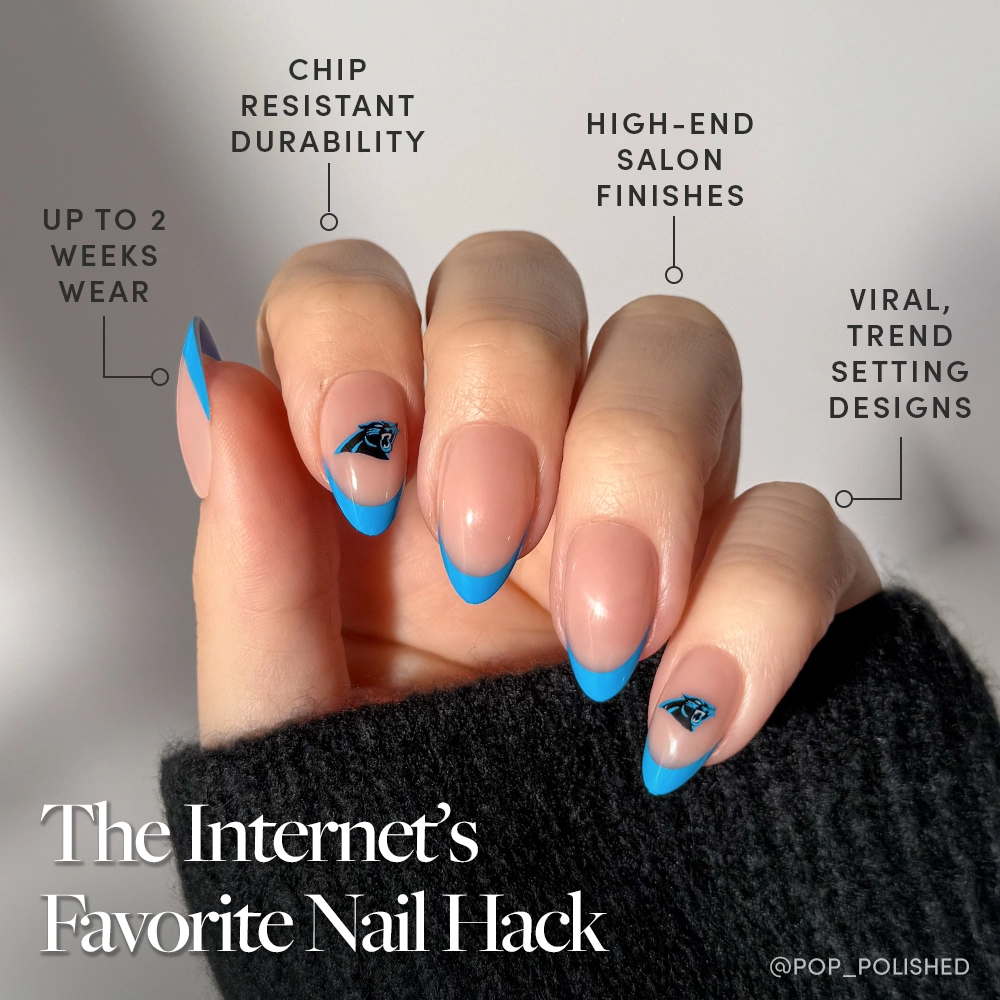 A hand with pink nails, blue French tips, and eye designs wears the Carolina Panthers Press-On Nail Set by glamnetic. Enjoy chip resistance, salon finishes, trendy styles, and up to 2 weeks’ wear. Caption: “The Internet’s Favorite Nail Hack.”. - Product image