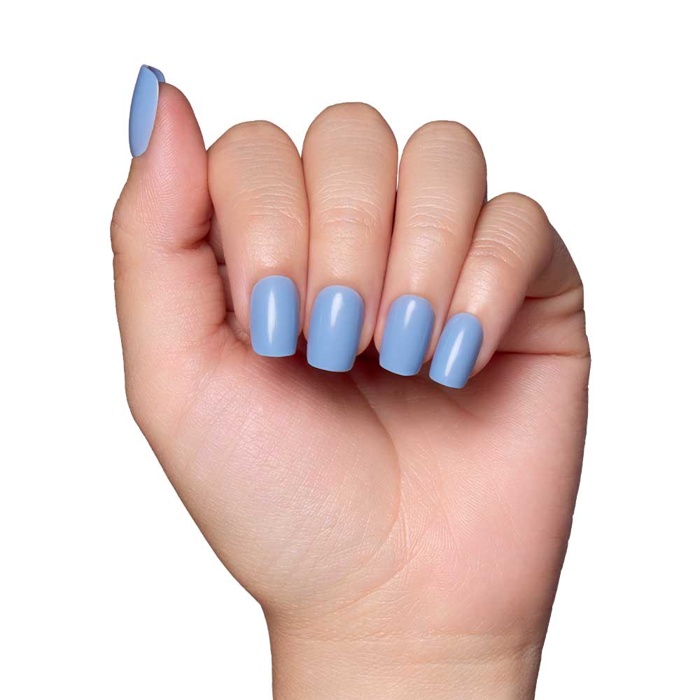 A hand with neatly manicured short squoval nails, painted in glamnetics Cashmere Blue vegan and cruelty-free nail set, exudes effortless elegance against a white background. - Product image