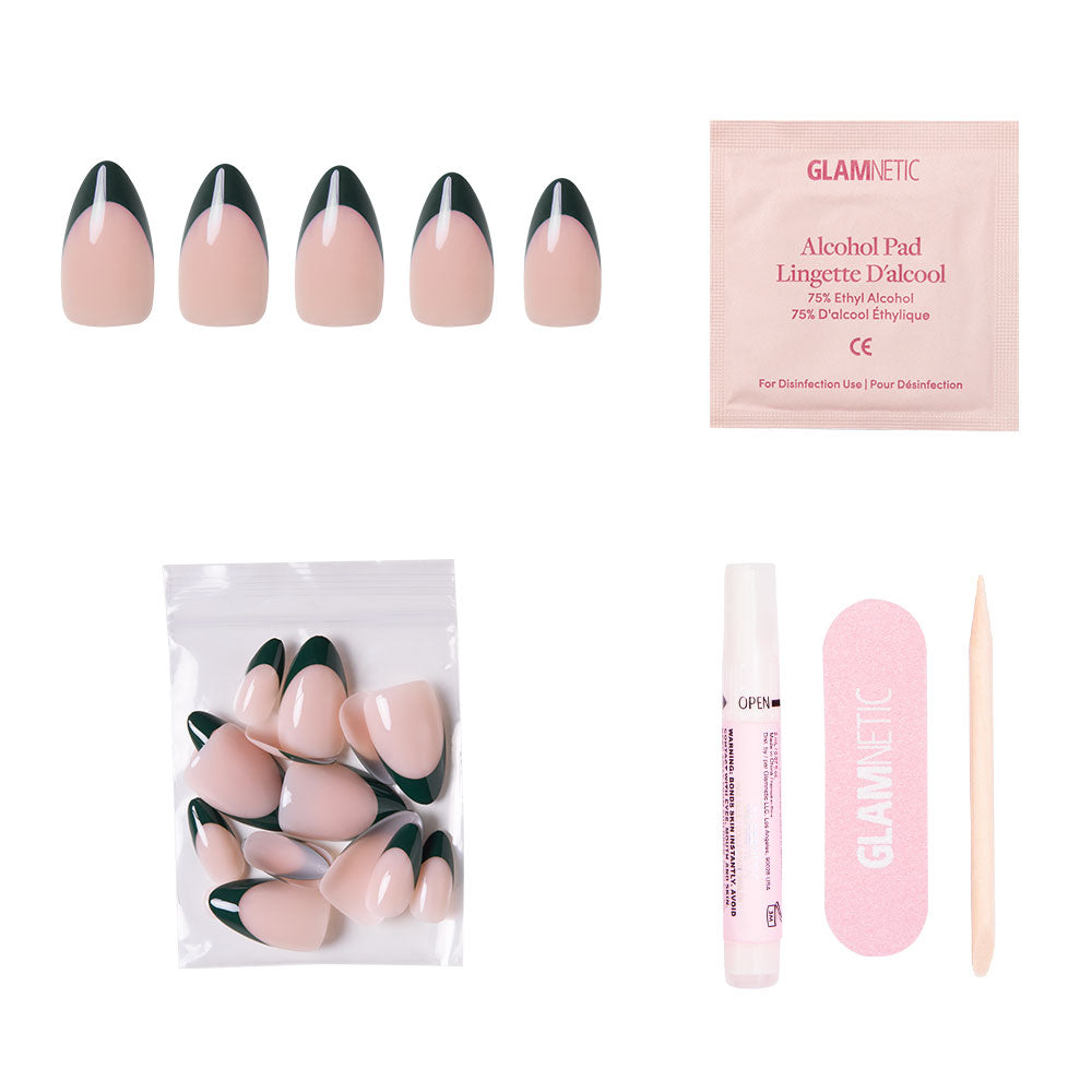 The glamnetic Château Nail Set includes short almond nude nails with dark green French tips, an alcohol pad, extra nails in a zip bag, nail glue, a pink file, and a wooden cuticle stick—displayed on a white background. - Product image