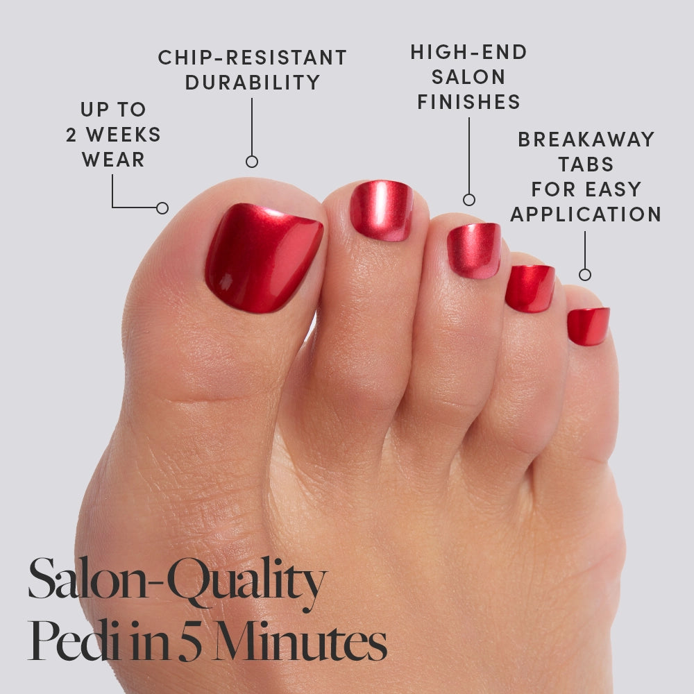 A foot wearing shiny, bold red color Glamnetic press-on toenails with product features called out, including salon finish and 2-week wear. - Product image