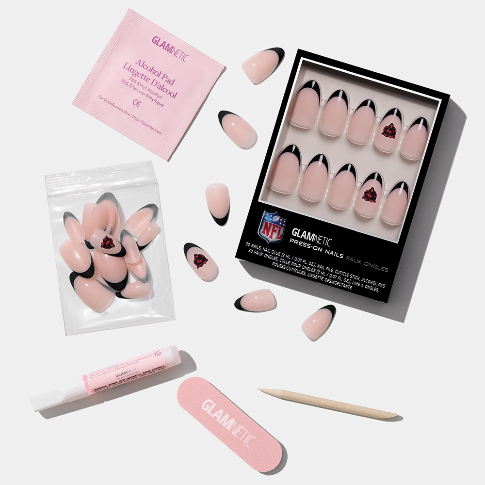 The glamnetic Chicago Bears Press-On Nail Set features pink nails with black tips and Bears logos, plus a nail file, cuticle stick, adhesive, alcohol pad, and extra nails—all shown on a white background. - Product image