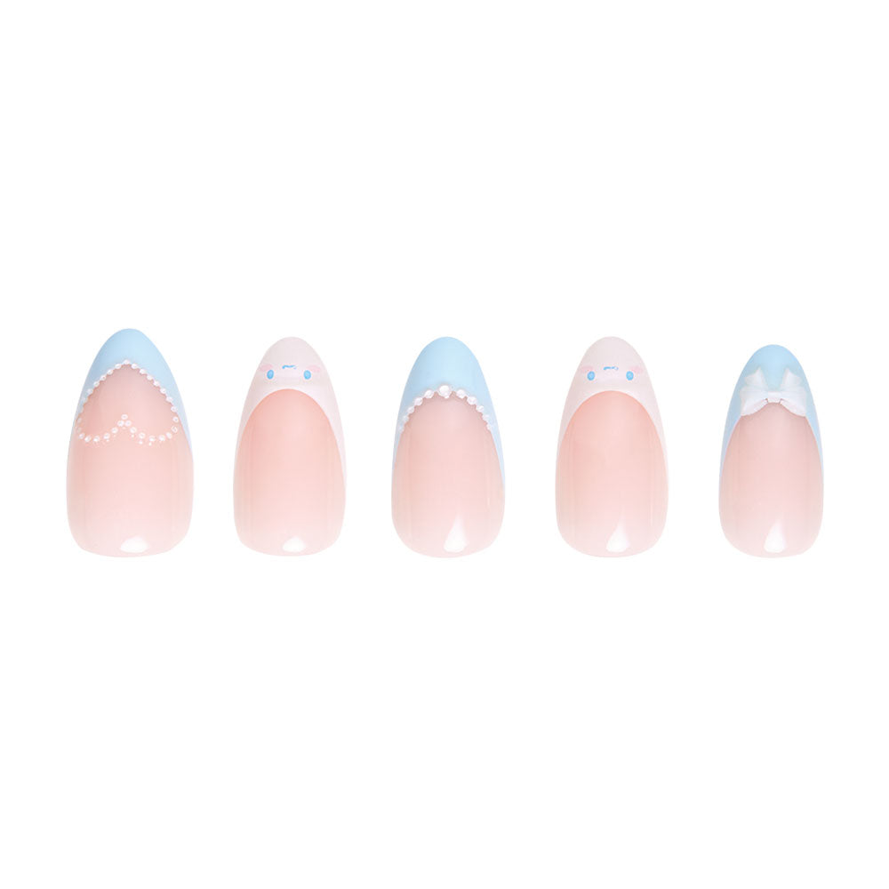 The glamnetic Cinnamoroll™ French Tip Short Almond Design Nail Set features five artificial nails with a soft pink base and unique pastel blue and white designs—dots, bow, scalloped tips, and Cinnamoroll accents—displayed on a white background. - Product image