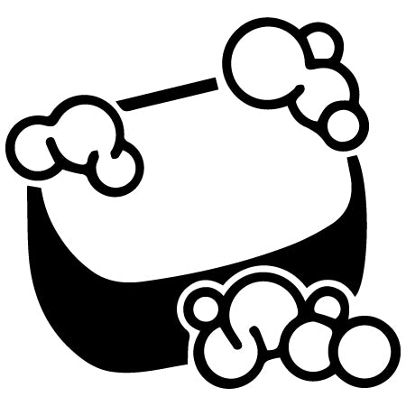 Black and white icon of a bar of soap with bubbly suds on top and around it, representing cleanliness or washing.