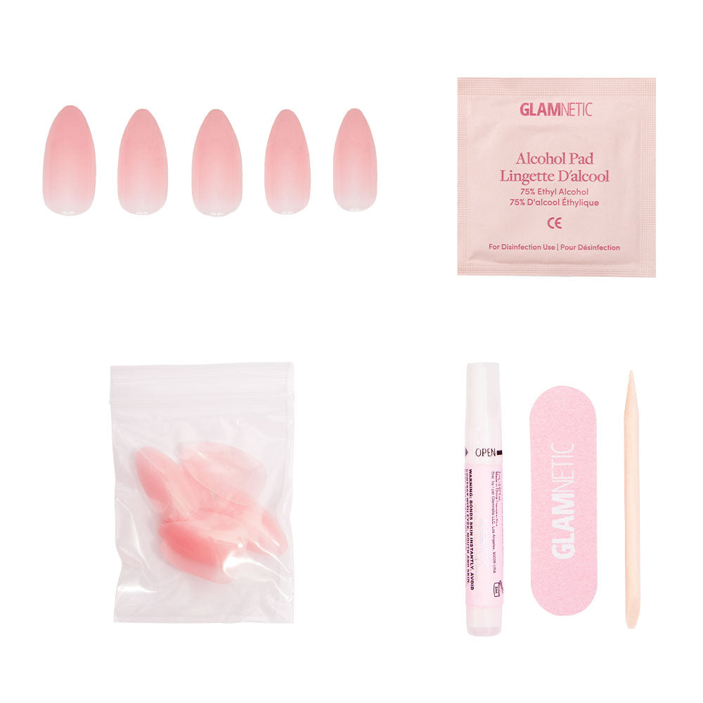 The glamnetic Cloud 9 kit includes five pink gradient, pointed almond press-on nails, an alcohol pad, extra nails in a resealable bag, nail glue, a pink file, and a wooden cuticle stick—all shown on a white background. - Product image