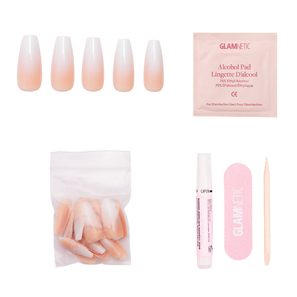 The Creme de Nude press-on nails by glamnetic feature a glossy finish and come with extra nails, glue, an alcohol pad, a pink nail file, and a wooden cuticle stick—all arranged on a white background. - Product image