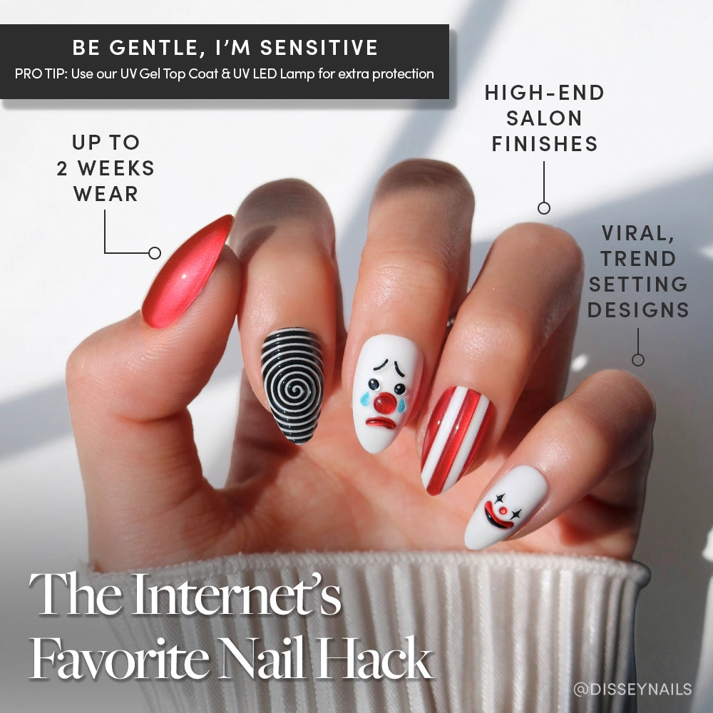 Crybaby Clown press-ons by glamnetic feature short almond nails in red chrome, black and white stripes, and playful 3D clown accents. Enjoy salon-quality, trendsetting designs with a flawless finish that lasts up to two weeks. - Product image