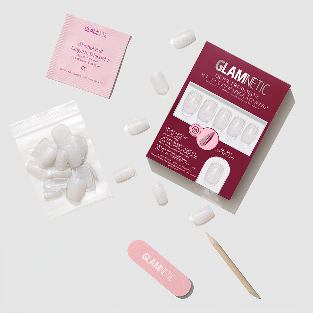 The glamnetic Daydream Veil press-on nail set includes packaging, a pink nail file, wooden cuticle stick, alcohol pad, nail glue, and extra nails—everything for the perfect at-home manicure, all arranged neatly on a light gray background. - Product image