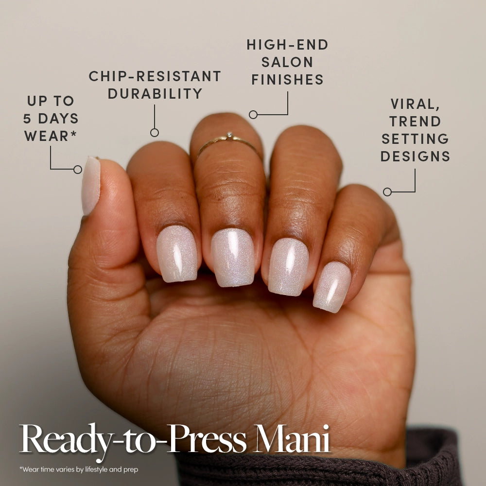 A hand displays Daydream Veil press-on nails by glamnetic in a short, pale pink style. Text highlights their chip-resistant durability, salon-quality finish, up to 5 days wear, and trendy viral designs. Caption: Ready-to-Press Mani. - Product image