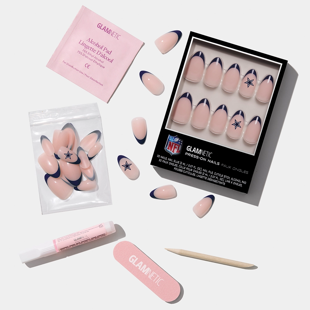 The glamnetic Dallas Cowboys Press-On Nail Set includes blue-tip nails with the Cowboys star logo, nail glue, a cuticle stick, nail file, alcohol pad, and extra nails— all arranged on a white surface. - Product image