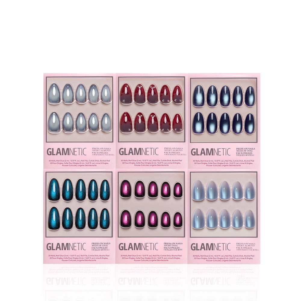 Six sets of Glamnetic Dark Magic press-on nails—silver, red, blue, teal, magenta, and light blue—are displayed in pink packaging against a white background. Each set from glamnetic features salon-quality durability and includes stunning velvet finish nails for an effortlessly chic look. - Product image