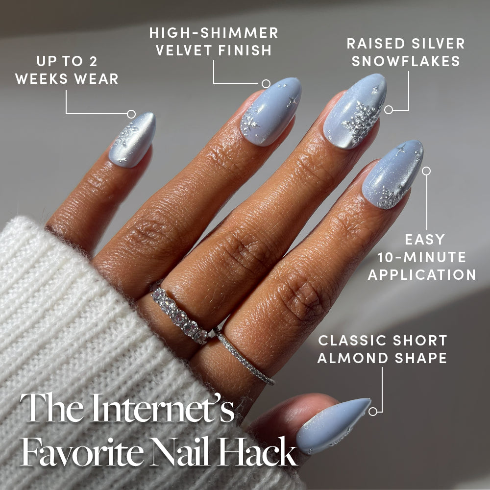 Glamnetic December Sky light blue, short almond press-on nails with a soft velvet effect, silver snowflake designs, and shimmer, shown in packaging that highlights 10-minute application and two weeks of wear. - Product image