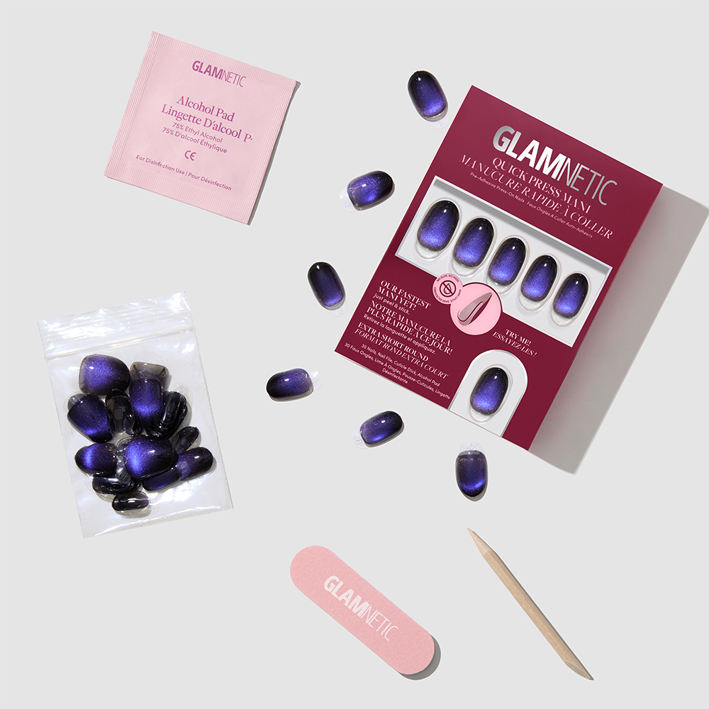 Discover the glamnetic Deep Winter press-on nails kit, showcasing extra short purple ombre nails along with a pink nail file, wooden cuticle stick, alcohol pad, and additional nails—all displayed on a light gray background. Enjoy effortlessly chic and cruelty-free nails with this easy-to-use set. - Product image