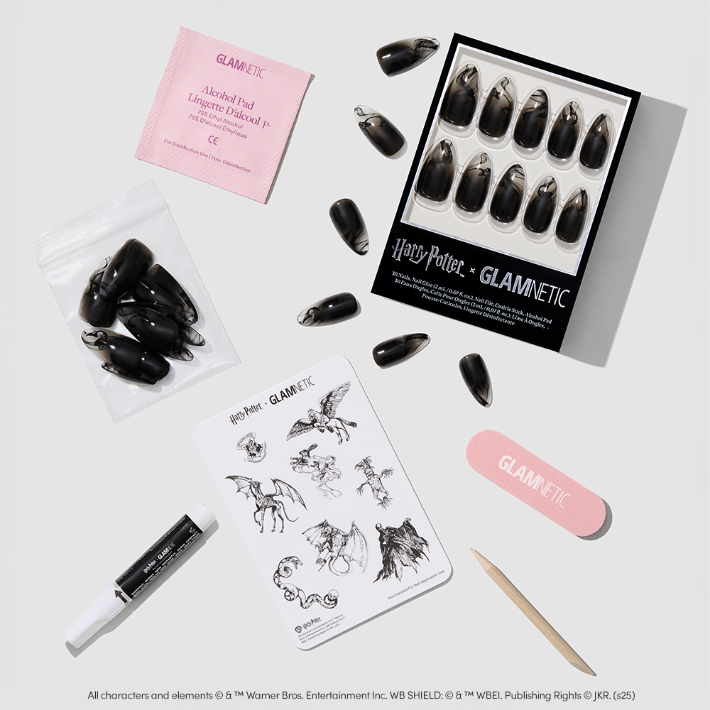 The glamnetic Dementor™ press-on nail set includes almond-shaped, black-to-clear gradient nails, magical creature stickers, nail glue, alcohol pad, file, cuticle stick, and extra nails. - Product image