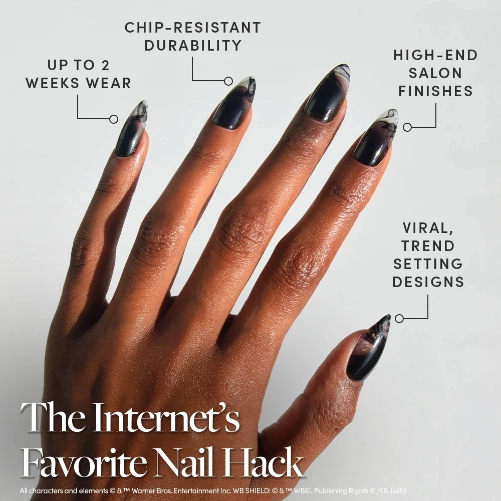 A hand wearing almond-shaped black Dementor⢠press-on nails with sheer wispy accents, featuring chip-resistant durability, two-week wear, and a salon finish. - Product image