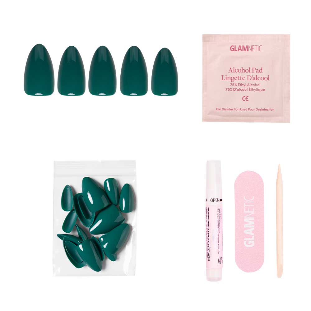 The Emerald Green short almond press-on nails by glamnetic feature a glossy finish and come with extra nails, nail glue tube, alcohol pad, pink file, and a wooden cuticle stick, all displayed on a white background. - Product image
