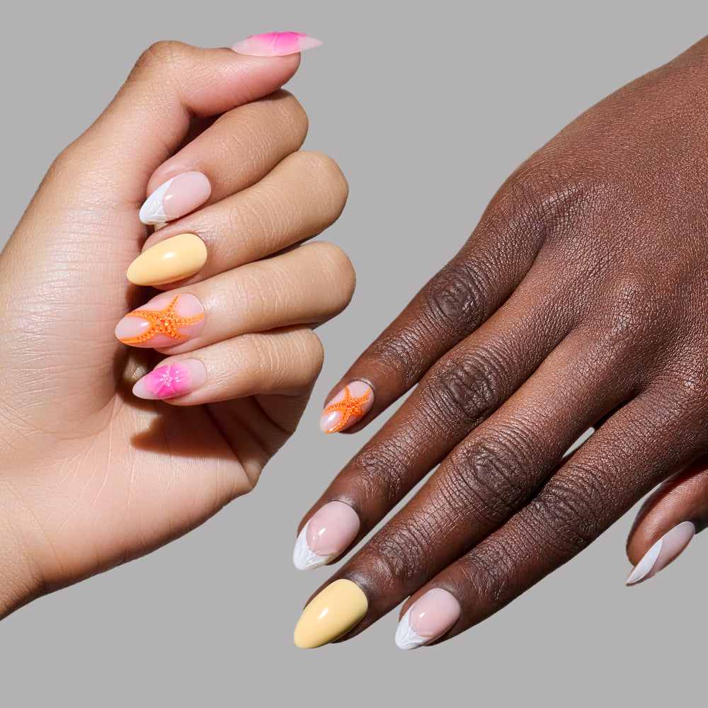 Two manicured hands showcase glamnetic’s Sunset Tide press-on nails: one hand with short almond shapes in pastel yellow and pink plus a 3D jelly starfish, the other with yellow, orange, and white French tips featuring wavy accents against a gray background. - Product image