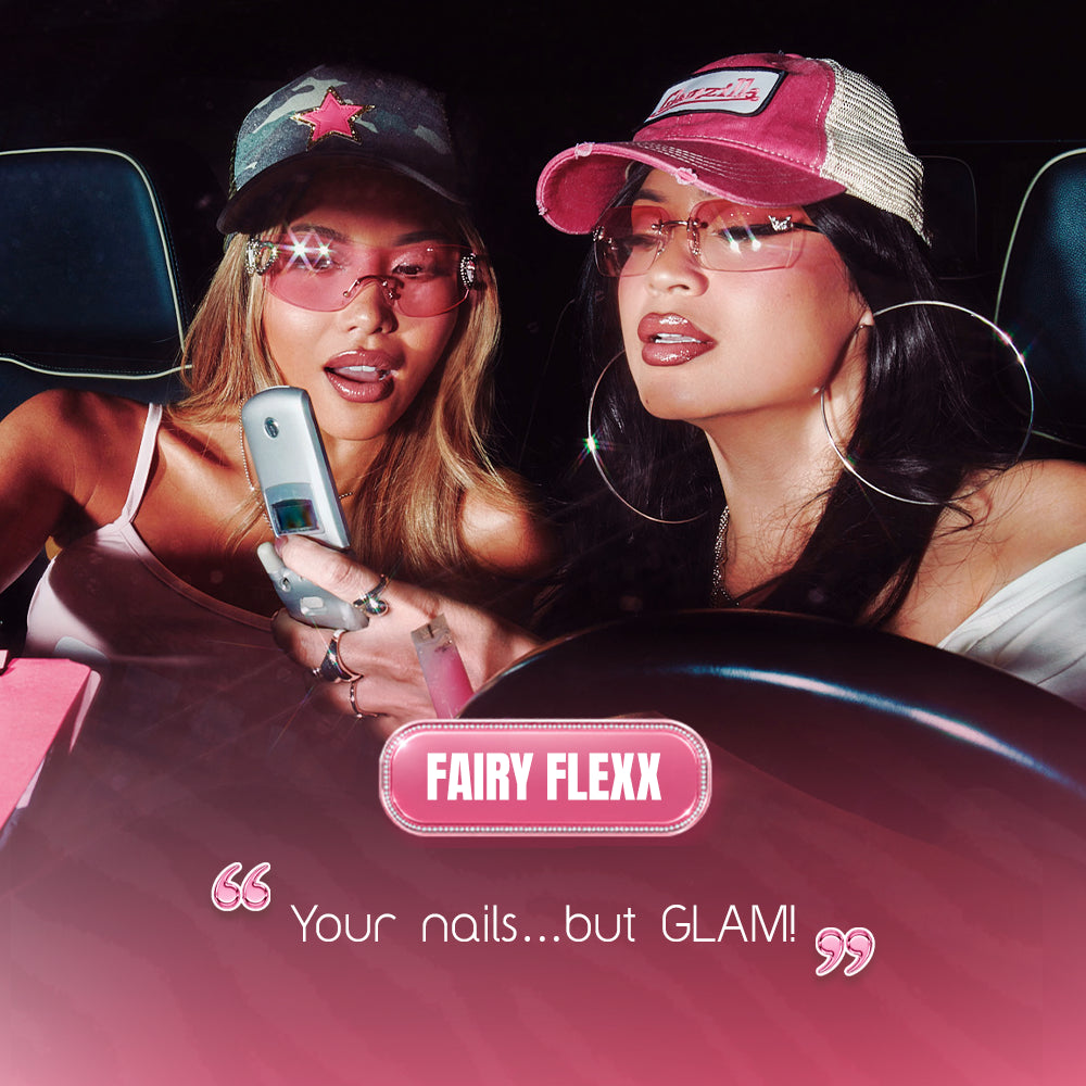 Two stylish women in pink caps and sunglasses sit in a car, one holding a flip phone. Below them, the text FAIRY FLEXX by glamnetic highlights their short almond press-on nails—vegan, cruelty-free, and full of retro glamour. - Product image